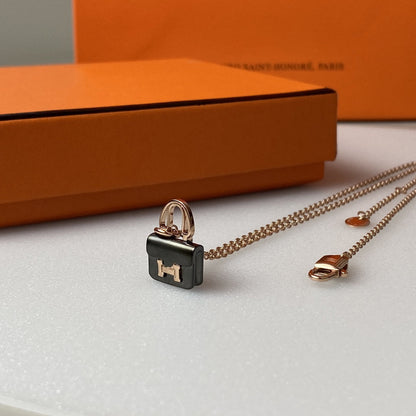 HERMES CONSTANCE BLACK PEDANT PINK GOLD NECKLACE