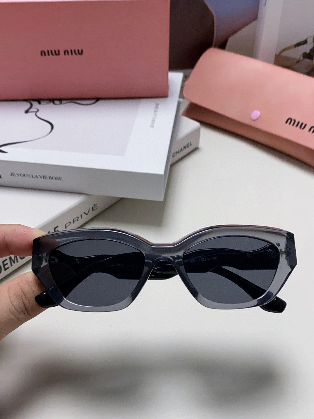 MIU MIU LOGO CAT EYE SUNGLASSES 513006 IN BLACK AND GREY CLEAR ACETATE WAVY FRAME